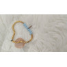 pulsera dorada con bolitas azul y pluma dorada(en el precio no están incluidos los gastos de envio)